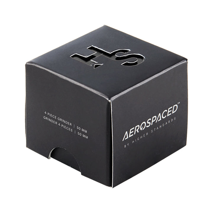 Black 4 piece Aeropspaced grinder inside it's black packaging