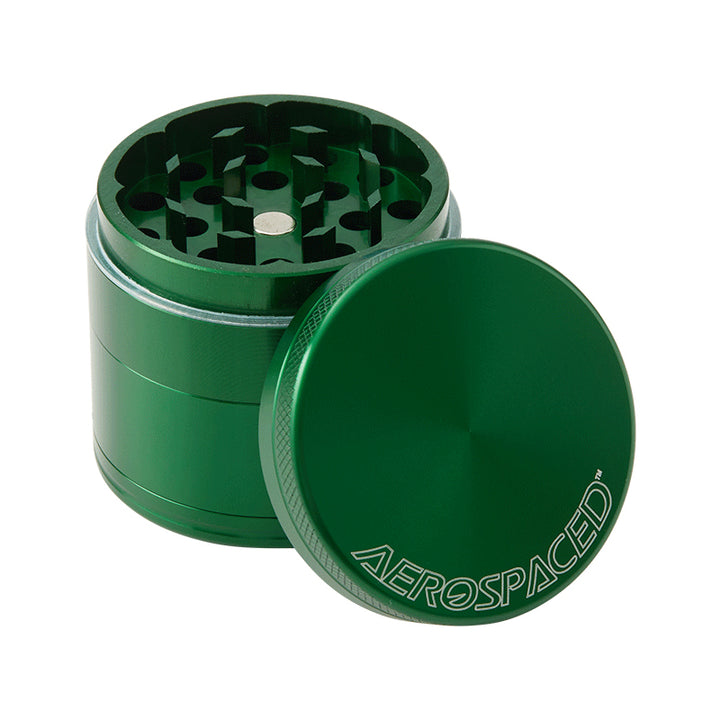 A Green 4 piece Aeropspaced grinder with it's lid off. It is Against a white background.