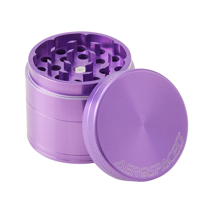 A Purple 4 piece Aeropspaced grinder with the lid off, against a white background.