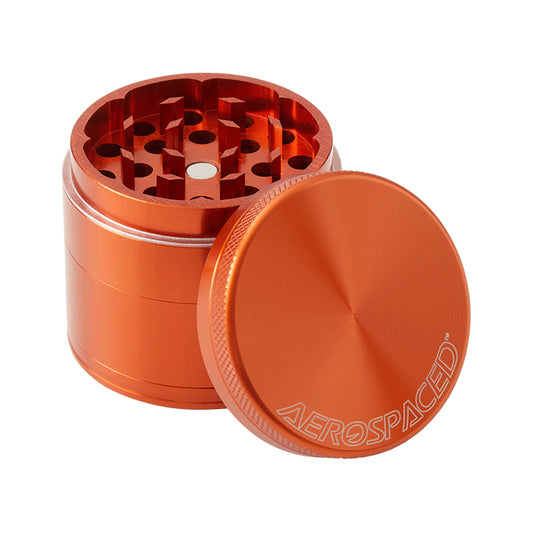 Orange 4 piece grinder with lid off, against a white background.