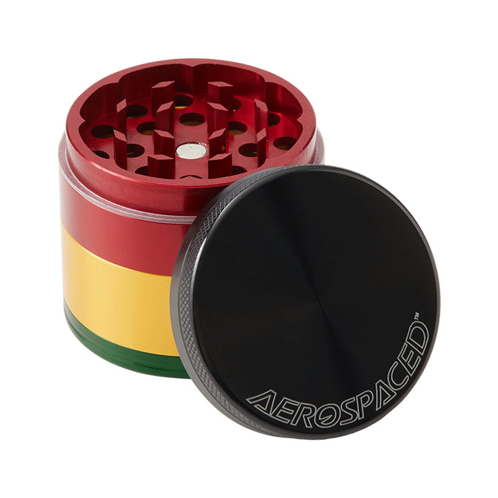 A Rasta coloured 4 piece Aerospaced grinder, with lid off.