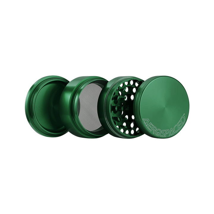 An open Large green 4 piece Aeropspaced grinder.