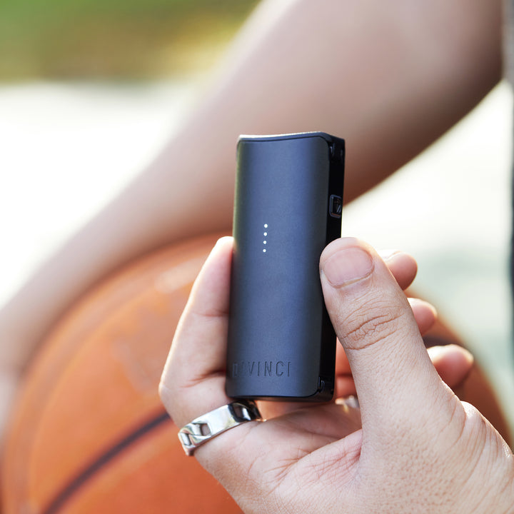 Blue Miqro-C vaporizer in womans hand.